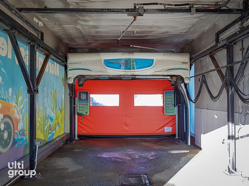 Orange Ulti Roll door installed in a Laserwash car wash bay.